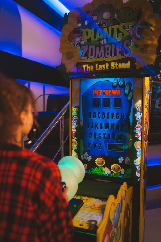 A person playing a Plants vs Zombies arcade game in an entertainment venue.
